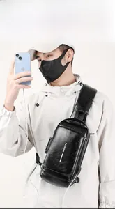 Detail of men's leather chest bag featuring anti-theft combination lock and USB charging port