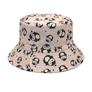 Close-up of pink bucket hat featuring cute cartoon penguin patterns and quality stitching