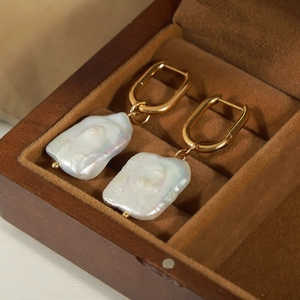Vintage 18K gold plated irregular freshwater pearl drop earrings on velvet display