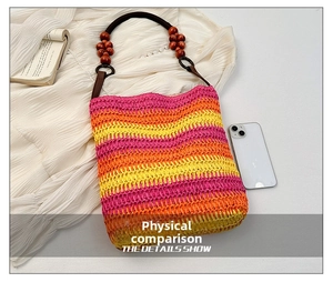 Detail of colorful rainbow woven beach bag with wooden beads on the dark brown handles