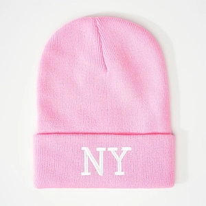 Pink knit beanie with white NY embroidery featuring a ribbed texture on white background