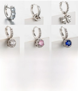 Detail showing various zircon bow earrings with silver copper finish and 8mm inner diameter