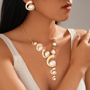 Metallic geometric necklace and earring set with white oval stones on model