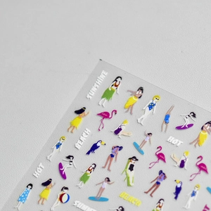 Detail of summer beach nail art stickers with cartoons, flamingos and beach motifs
