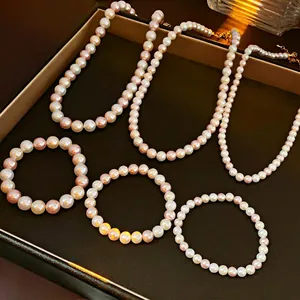 Elegant white and pink pearl necklace and bracelet jewelry set with golden clasps
