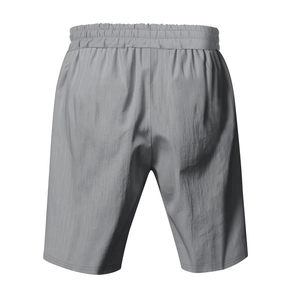 Detail view of grey linen-textured beach shorts featuring an elastic drawstring waistband