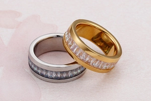 Detail of silver and gold eternity rings with emerald-cut crystals in a luxury layout
