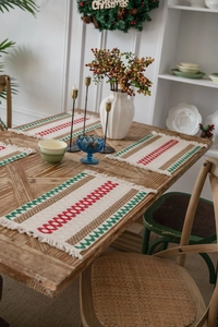 Detailed Christmas cotton linen placemats with festive red green geometric weave and tassels