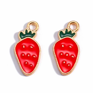 Detailed view of two strawberry alloy pendants with red enamel and gold leaf accents