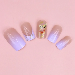 Detail of purple ombre press-on nails featuring butterfly patterns and gold foil accents
