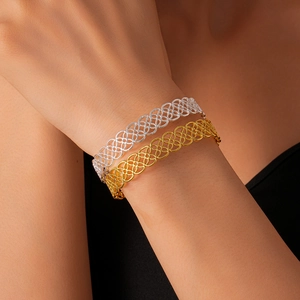 Detailed close-up showing the intricate hollow metal lace texture on gold and silver bangles