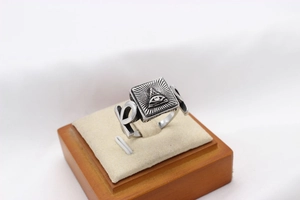 Macro shot of vintage silver steel ring featuring All-Seeing Eye and Ankh symbol details
