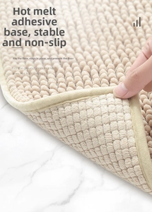 Detailed view of non-slip hot melt adhesive backing on cream chenille bath mat
