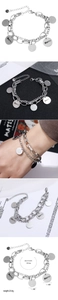 Detailed view of silver stainless steel double chain bracelet with engraved Merci pendants