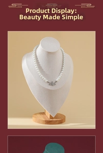 Detailed view of pearl necklace with silver orb pendant on a premium display stand