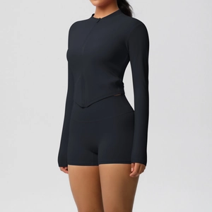 Detail of black sports yoga set showing high-waisted shorts and slim-fit zipper jacket