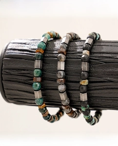 Detail of beaded men's bracelets with tiger eye, agate stones and square metal spacers