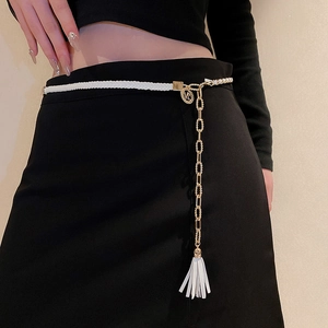 Detail of white braided leather waist chain with gold metal links and M charm
