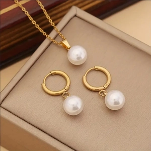 Classic gold jewelry set featuring elegant white pearl pendant necklace and hoop earrings