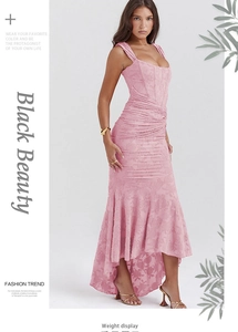 Detailed close-up of pink jacquard floral fabric and layered waist pleats on maxi dress