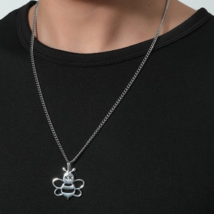 Close-up of minimalist silver bee pendant with hollow wing detail on a thin chain