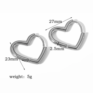 Detail view of silver heart earrings with dimensions 27mm x 23mm and 5g weight