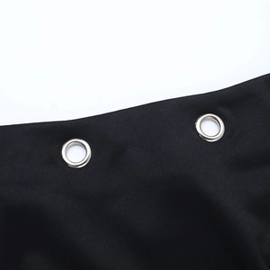 Close-up of dual silver metal eyelets on black fabric showing fine texture and quality