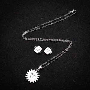 Polished silver stainless steel jewelry set featuring smiling sun pendant and stud earrings