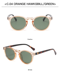 Detail view of retro round sunglasses in orange hawksbill frame with green lenses