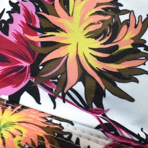 Close-up of tropical floral fabric texture and reinforced stitching on the reversible hat
