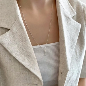 Minimalist 925 sterling silver snake chain necklace worn with an elegant beige blazer