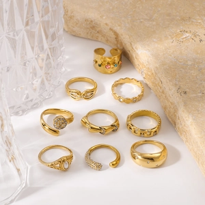 9-piece vintage gold stainless steel ring set with pearls and crystals on white surface