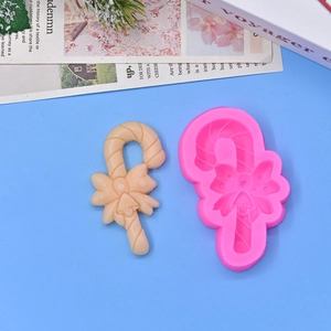 Pink silicone mold with Christmas candy cane and bell shapes for DIY baking and cakes