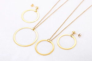 Detailed view of the gold hollow geometric circle necklace and matching stud earrings set