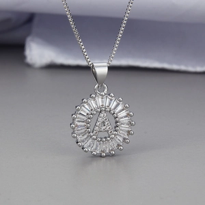 Close-up of silver letter A pendant necklace with baguette and round cubic zirconia stones