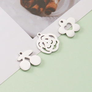 Close-up of polished stainless steel cherry, rose and heart-shaped flower pendants