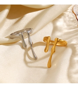 Lava drip rings in gold and silver on cream silk with elegant blind shadows detail