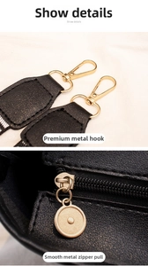 Close-up of premium light gold hardware and smooth zipper on the black leather tote bag