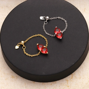 Detail of adjustable heart rings with red cubic zirconia on a black display base