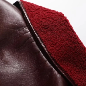 Macro shot of burgundy leather texture with thick deep red faux fur lining detail