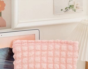 Close-up of pink waffle fabric texture on a portable large capacity cosmetic bag