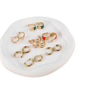 Stylish gold alloy earrings set with pearls, pink zircon and colorful enamel on white tray