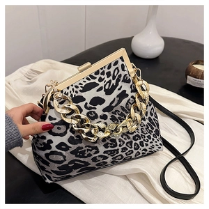 Macro shot of stylish leopard print shell bag with chunky gold chain handle detail