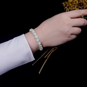 Detail view of 5mm sparkling tennis bracelet with round cubic zirconia on model's wrist