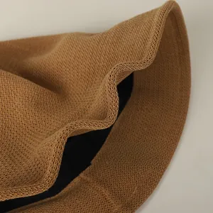 Detail of a foldable khaki sun hat showing the flexible knit texture and shapeable brim