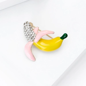 Detail of pink enamel banana brooch with sparkling crystal rhinestones and gold pin back