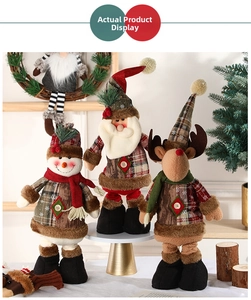 Close-up of Christmas plush dolls with reindeer and snowman in festive plaid outfits