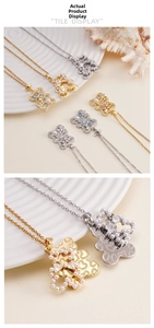 Close-up of bear-shaped pendant with inlaid pearls and crystals on thin metal chains