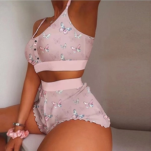 Detail of lavender butterfly print sleepwear set featuring button camisole and ruffled shorts