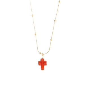 Minimalist gold beaded necklace with red natural stone cross pendant on white background